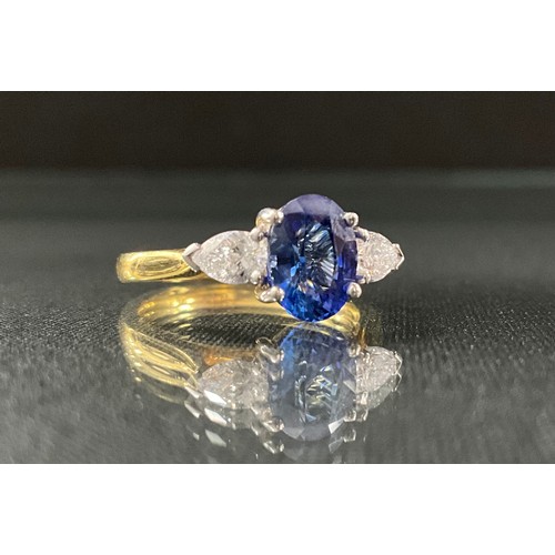 250 - A sapphire and diamond ring, central oval mid blue sapphire, approx 1.63ct, set between pear cut dia... 