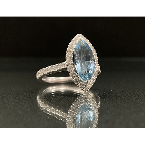 268 - An Aquamarine and diamond marquise ring, central marquise cut aquamarine approx 1.51ct, surrounded b... 