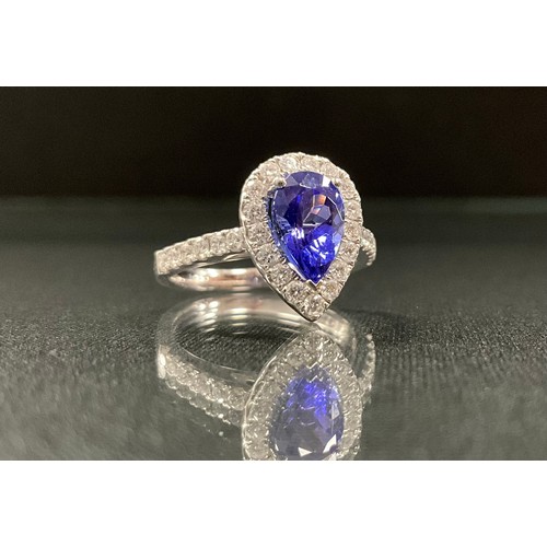 256 - A tanzanite and diamond ring, pear drop tanzanite approx 1.65ct, surrounded by a halo of round brill... 