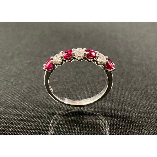 244 - A ruby and diamond ring, alternate set with four red rubies and three round brilliant cut diamonds, ... 