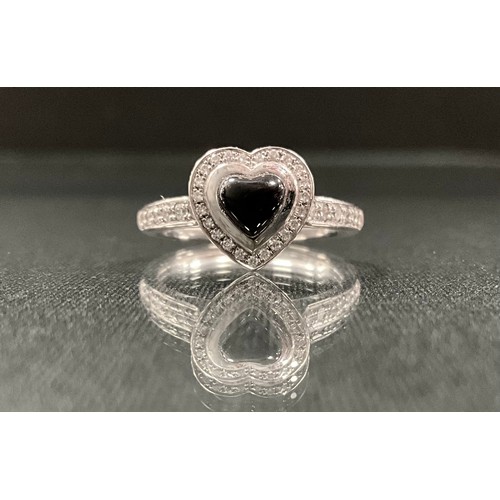 215 - A Krieger diamond and jet heart ring, central jet heart cabochon surrounded by round brilliant cut d... 