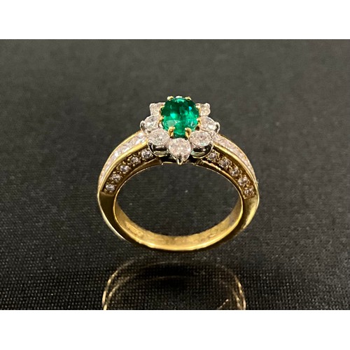 286 - An emerald and diamond cluster ring, central oval vibrant green emerald, 0.75ct, surrounded by eight... 