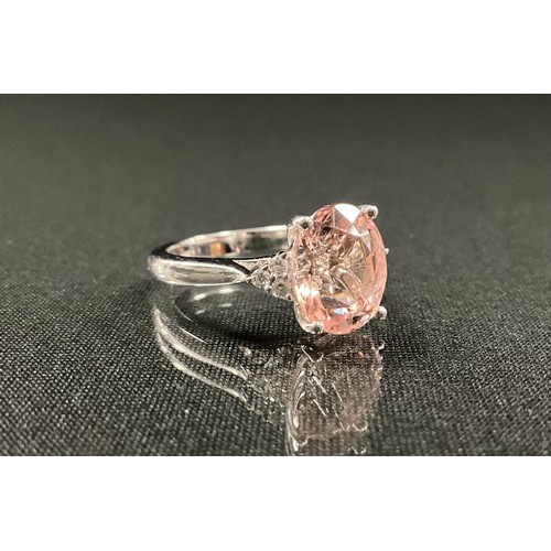 220 - A morganite and diamond ring, oval peachy pink morganite approx 3.50ct, set between triangular clust... 