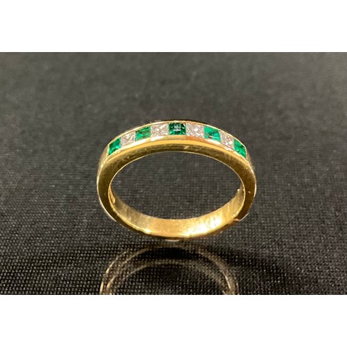 289 - An emerald and diamond half eternity ring, alternate set with five princess cut emeralds and four pr... 