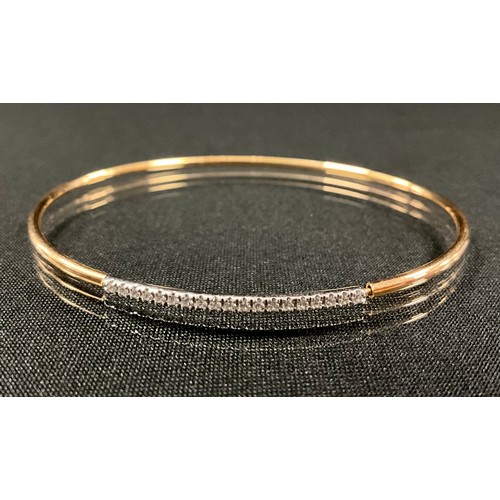 186 - A diamond 18ct rose gold bangle, set with nineteen round brilliant cut diamonds, total diamond weigh... 