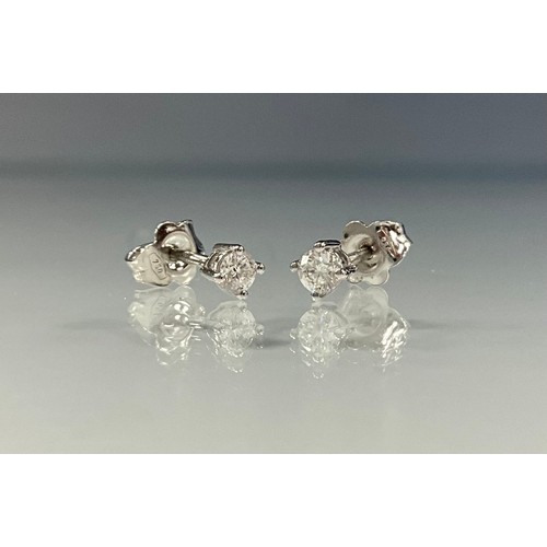 228 - A pair of diamond solitaire stud earrings, total diamond weight, 0.25ct, 18ct white gold mount, 1g g... 