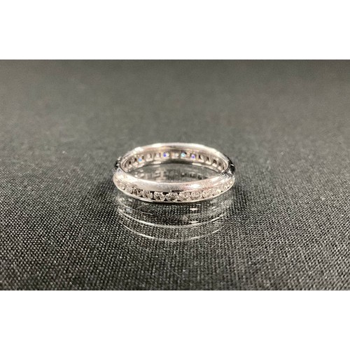 297 - An Ullmans diamond eternity ring, channel set with round brilliant cut diamonds, total estimated dia... 