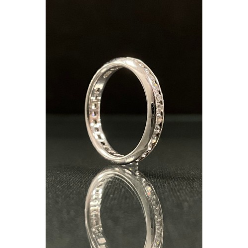 297 - An Ullmans diamond eternity ring, channel set with round brilliant cut diamonds, total estimated dia... 