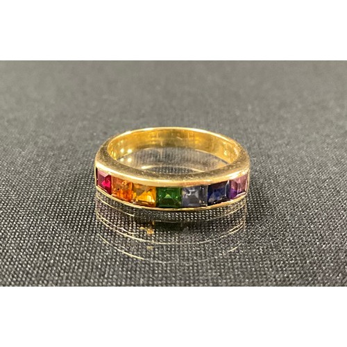 An 18ct gold rainbow ring, set with seven different colour square cut ...