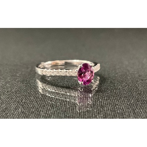 237 - A pink sapphire and diamond ring, oval pink sapphire, 0.33ct, above round brilliant cut diamond acce... 