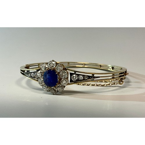 248 - A sapphire and diamond hinge bangle, central vibrant blue circular sapphire approx 1.90ct, surrounde... 