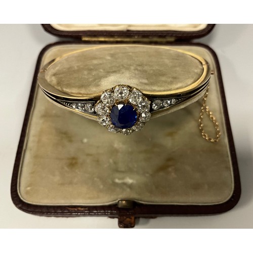 248 - A sapphire and diamond hinge bangle, central vibrant blue circular sapphire approx 1.90ct, surrounde... 