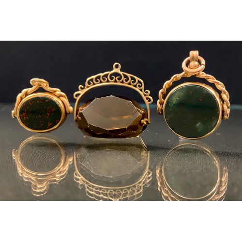 260 - A Victorian oval bloodstone and carnelian swivel fob, plain matrices, 18ct gold mount, Birmingham 18... 