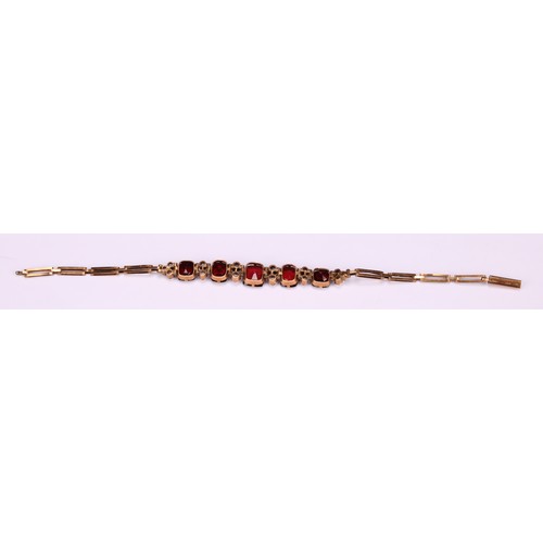 261 - A Victorian paste garnet and diamond effect bracelet, unmarked yellow metal mount and bracelet, 16.5... 