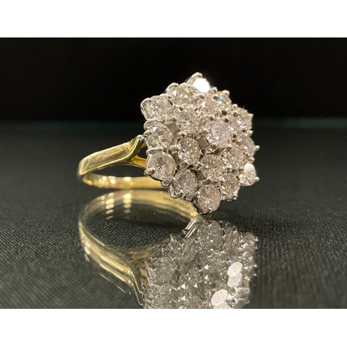 212 - A hexagonal diamond cluster ring, three stepped layers of round brilliant cut diamonds, totalling ni... 