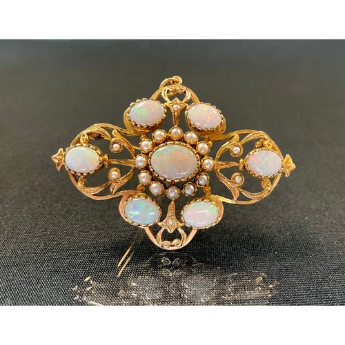 295 - An opal and seed pearl pendant brooch, scrolling mount set with seven oval opals and eighteen seed p... 