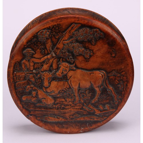 623 - Snuff - A 19th century circular pressed walnut snuff box, the cover decorated with a farmer, cattle ... 