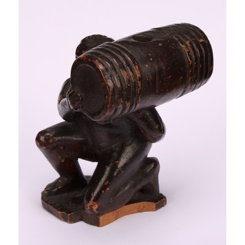 641 - Snuff - a 19th century novelty treen snuff box, carved as the pooping man, squatting holding a barre... 