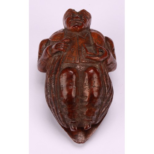 637 - Snuff - a 19th century novelty coquilla nut snuff box, carved as a French infantryman dressed in uni... 