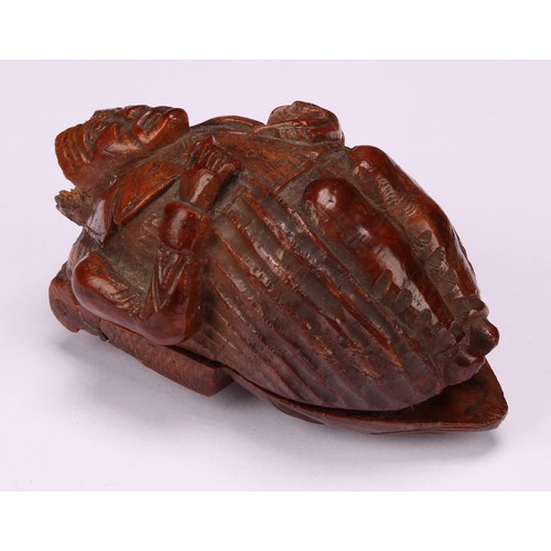 637 - Snuff - a 19th century novelty coquilla nut snuff box, carved as a French infantryman dressed in uni... 