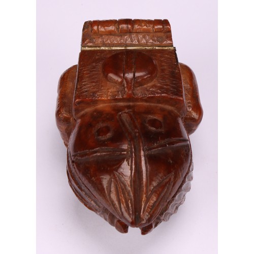 637 - Snuff - a 19th century novelty coquilla nut snuff box, carved as a French infantryman dressed in uni... 