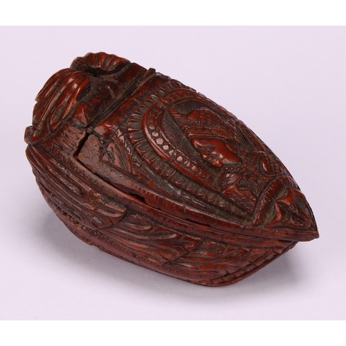 625 - Snuff - a 19th century coquilla nut bugbear snuff box, carved as a novelty shoe, the cover carved wi... 