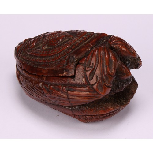 625 - Snuff - a 19th century coquilla nut bugbear snuff box, carved as a novelty shoe, the cover carved wi... 