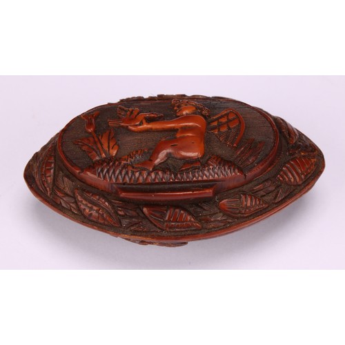 631 - Snuff - a 19th century navette shaped coquilla nut snuff box, carved with musical trophies and cupid... 