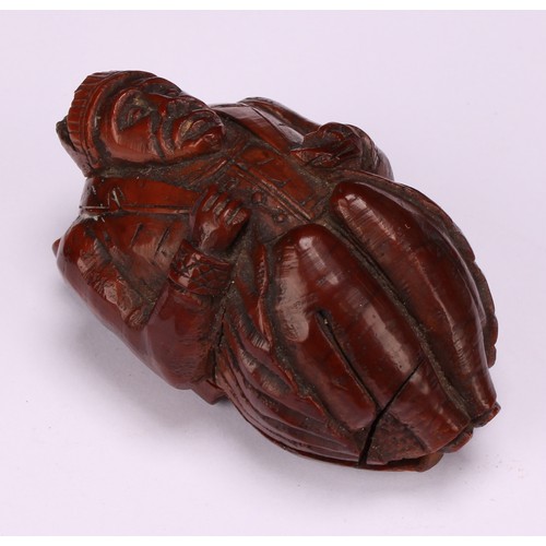 636 - Snuff - a 19th century novelty coquilla nut snuff box, carved as a French infantryman dressed in uni... 