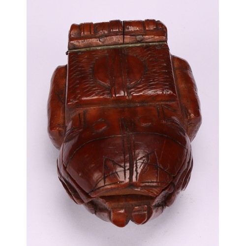 636 - Snuff - a 19th century novelty coquilla nut snuff box, carved as a French infantryman dressed in uni... 