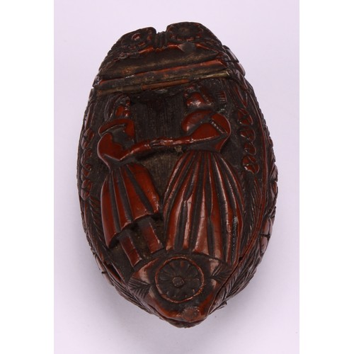 627 - Snuff - a 19th century coquilla nut bugbear snuff box, carved with floral roundels and urns planted ... 