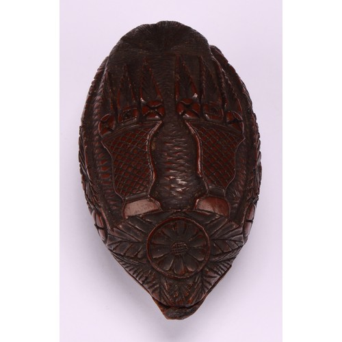 627 - Snuff - a 19th century coquilla nut bugbear snuff box, carved with floral roundels and urns planted ... 