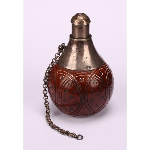 628 - Snuff - a 19th century coquilla nut snuff flask of squared spherical form, the sides with turned rou... 