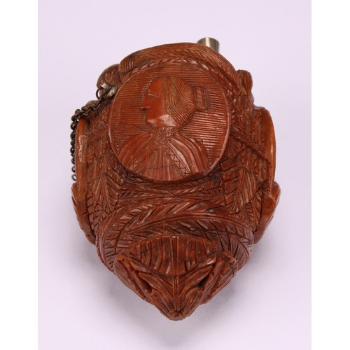 634 - Snuff - a 19th century novelty coquilla nut bugbear snuff flask, carved with oval portrait cameos wi... 