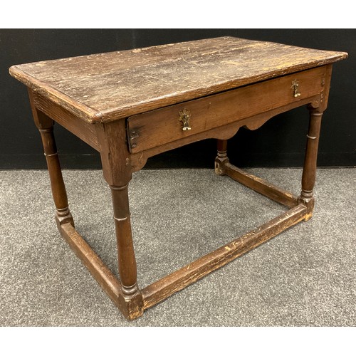 875 - An 18th century oak low boy, over-sailing rounded rectangular top, with a single long drawer to frie... 