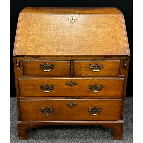 1123 - A George III oak bureau, of small proportions, fall door to top enclosing a fitted interior, with ce... 