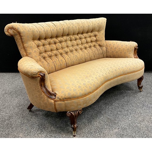 1266 - A Victorian walnut sofa, of small proportions, deep-buttoned stuffed-over upholstery, carved scroll ... 