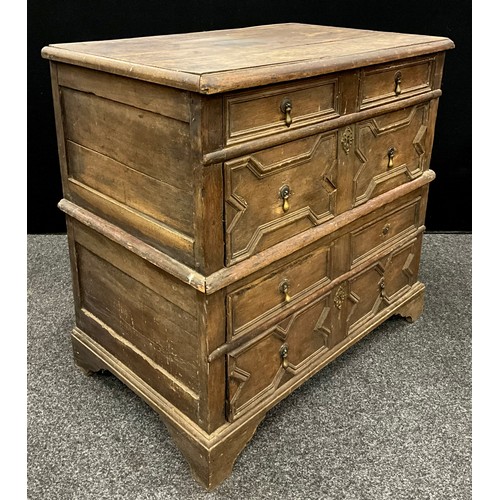 869 - A William III oak chest, of split construction, oversailing top above four long drawers applied with... 