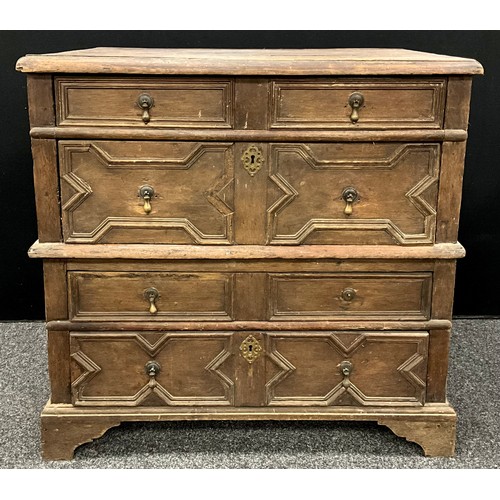 869 - A William III oak chest, of split construction, oversailing top above four long drawers applied with... 