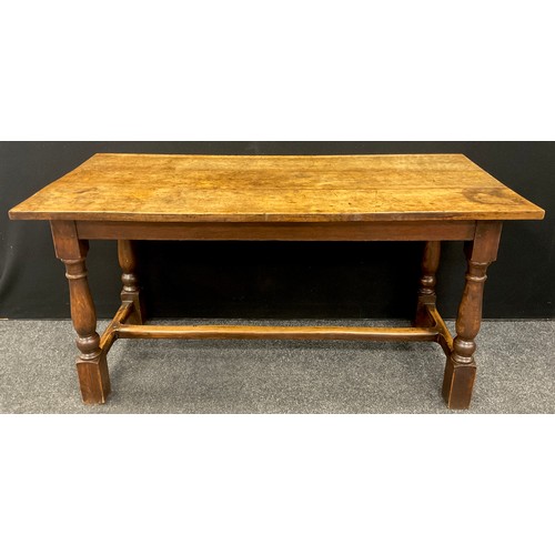 1053 - A late 18th / early 19th century oak plank top trestle table, 74.5cm high x 148cm x 68.5 cm.