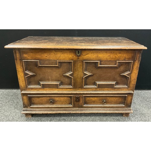 1054 - A late 18th century Jacobean revival small oak mule chest, 69cm high x 106cm wide x 51cm deep.