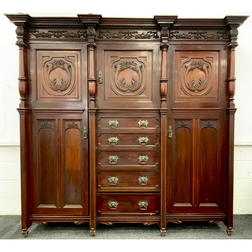 1051 - A large late Victorian mahogany compactum wardrobe, moulded cornice above a central cupboard and fiv... 