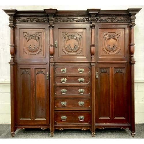 1051 - A large late Victorian mahogany compactum wardrobe, moulded cornice above a central cupboard and fiv... 