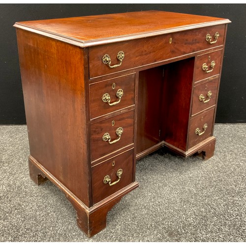 1116 - A George III mahogany kneehole desk, rectangular moulded top above a cock beaded long drawer and thr... 