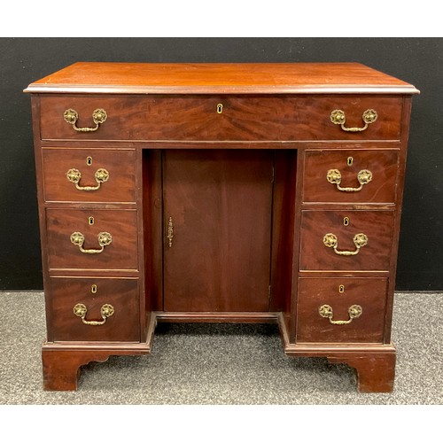 1116 - A George III mahogany kneehole desk, rectangular moulded top above a cock beaded long drawer and thr... 