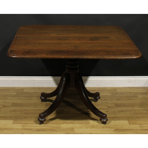 905 - A George IV oak breakfast table, rounded rectangular tilting top with moulded edge, turned column, s... 