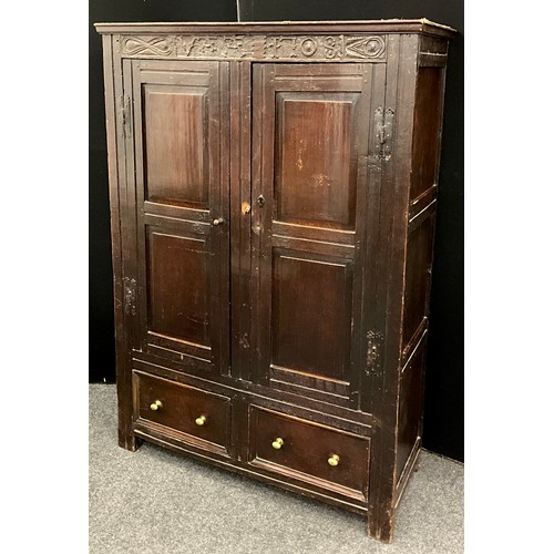 865 - A Charles II oak panelled hall cupboard, out-swept cornice above a carved frieze and a pair of panel... 