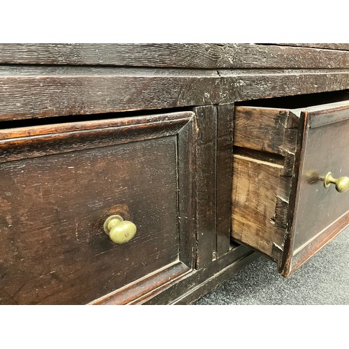 865 - A Charles II oak panelled hall cupboard, out-swept cornice above a carved frieze and a pair of panel... 