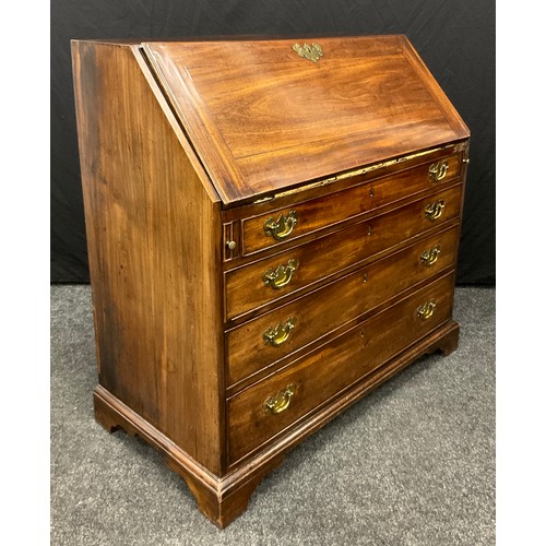 1113 - A George III mahogany bureau, fall front enclosing an arrangement of pigeon holes and small drawers ... 