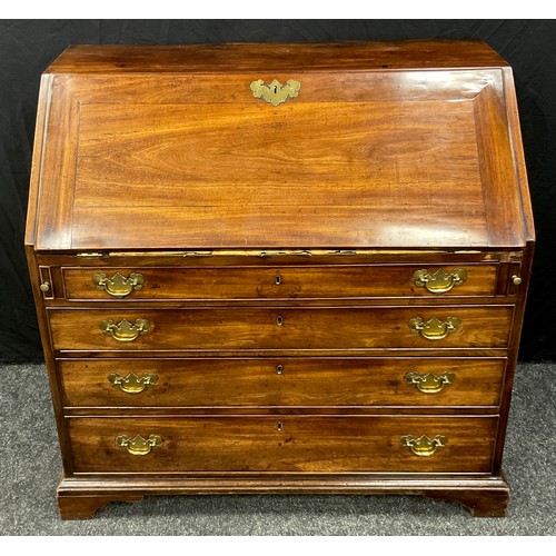 1113 - A George III mahogany bureau, fall front enclosing an arrangement of pigeon holes and small drawers ... 